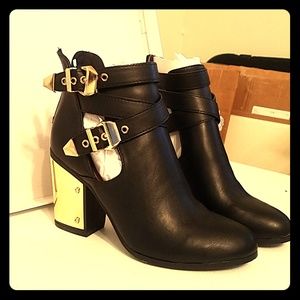 Black ankle boots with gold accents